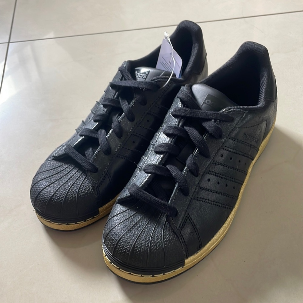 original superstar adidas all black with gold sole